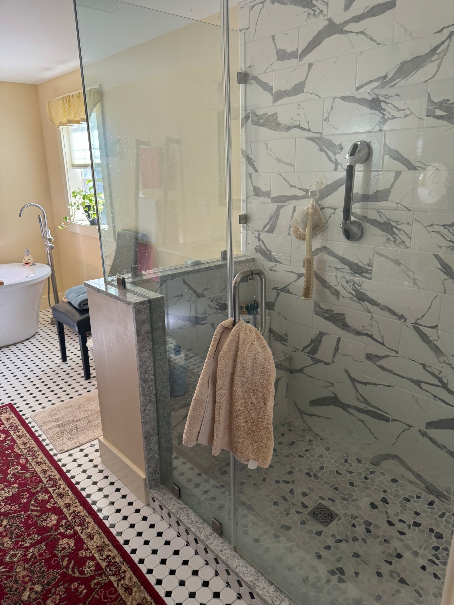 A bathroom with a walk in shower and a bathtub