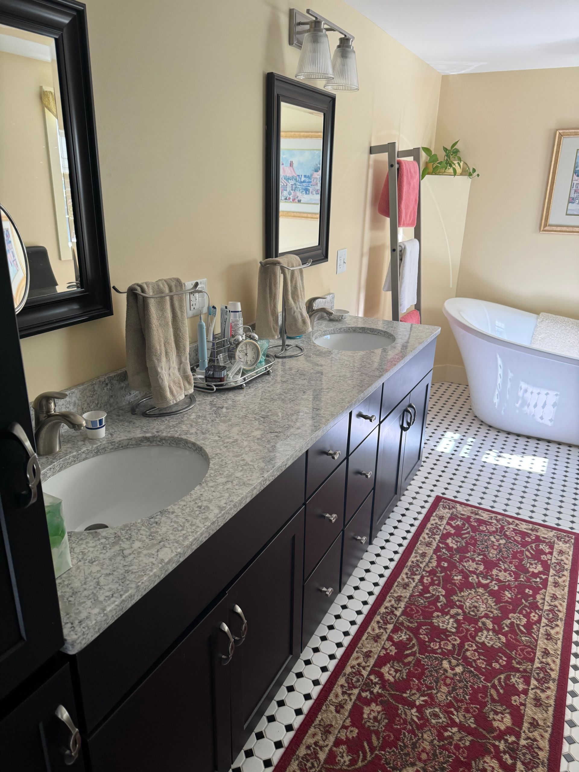 A bathroom with two sinks and a tub