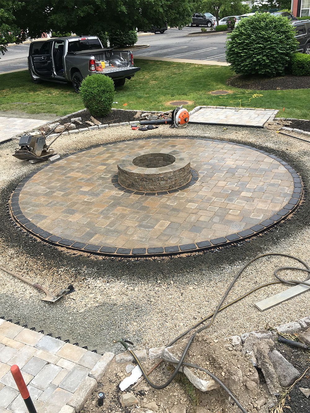 A fire pit is being built in the middle of a driveway.