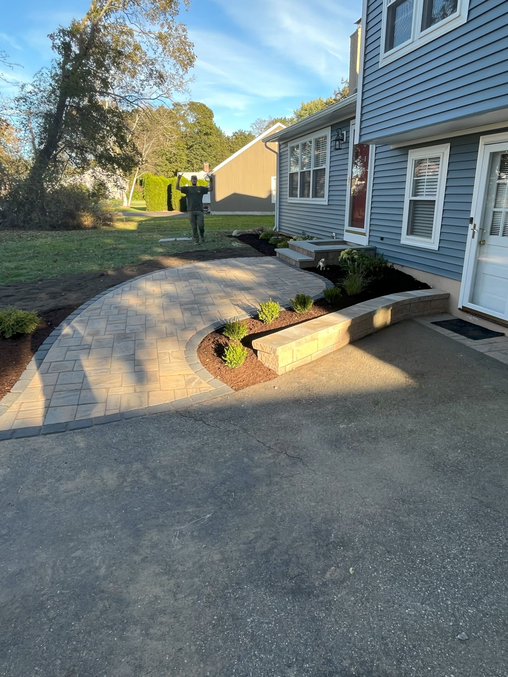 There is a walkway leading to the front door of a house.