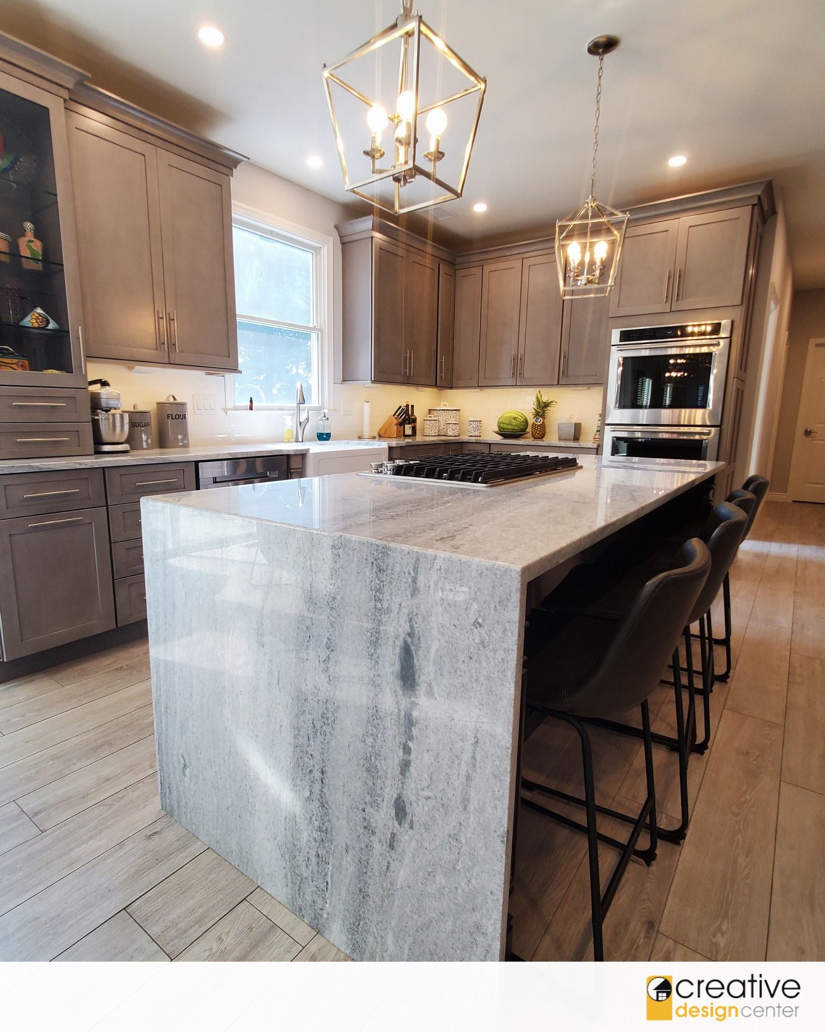 A kitchen with a large island and stools.