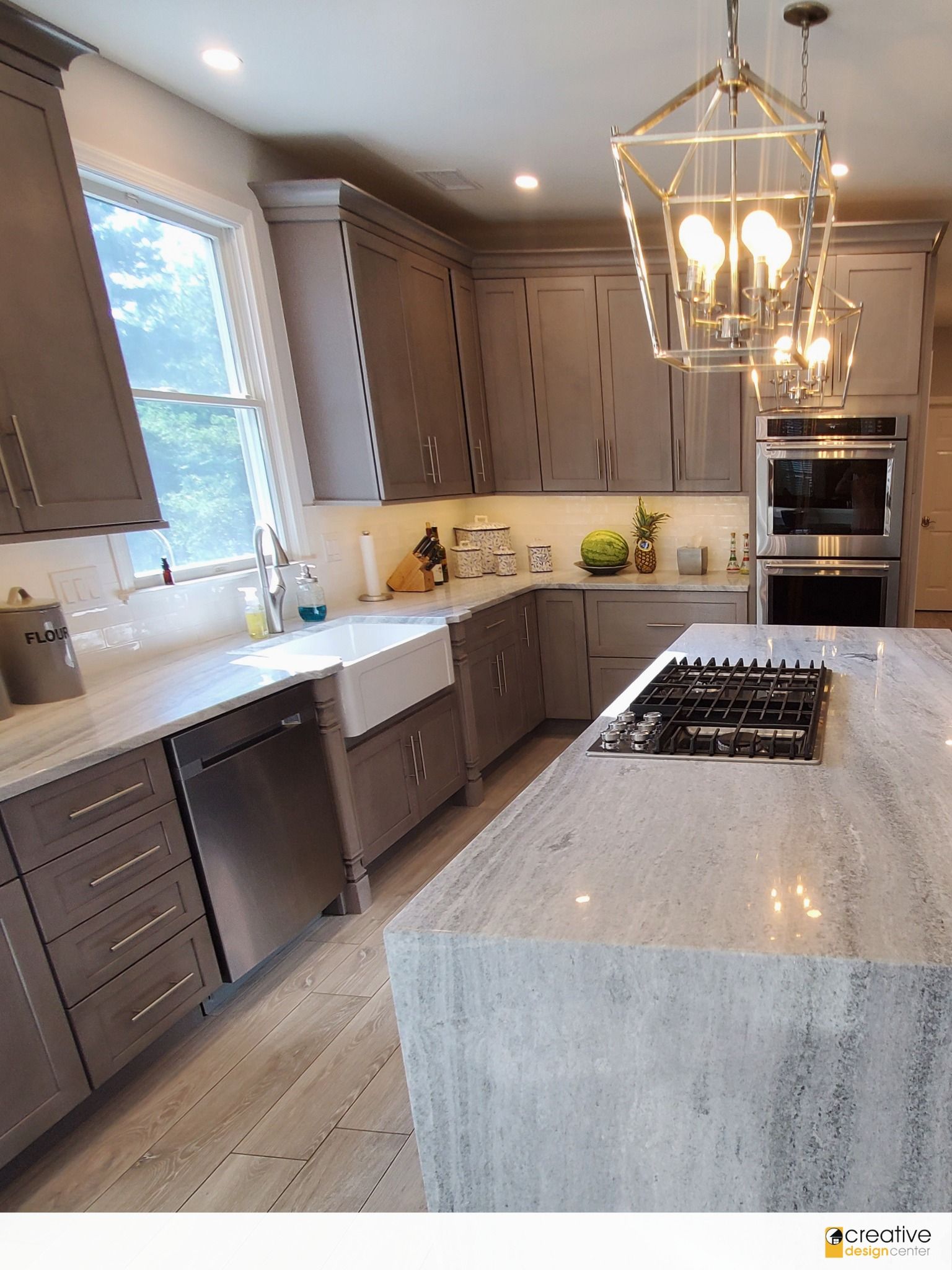 A kitchen with a large island and a stove top oven.