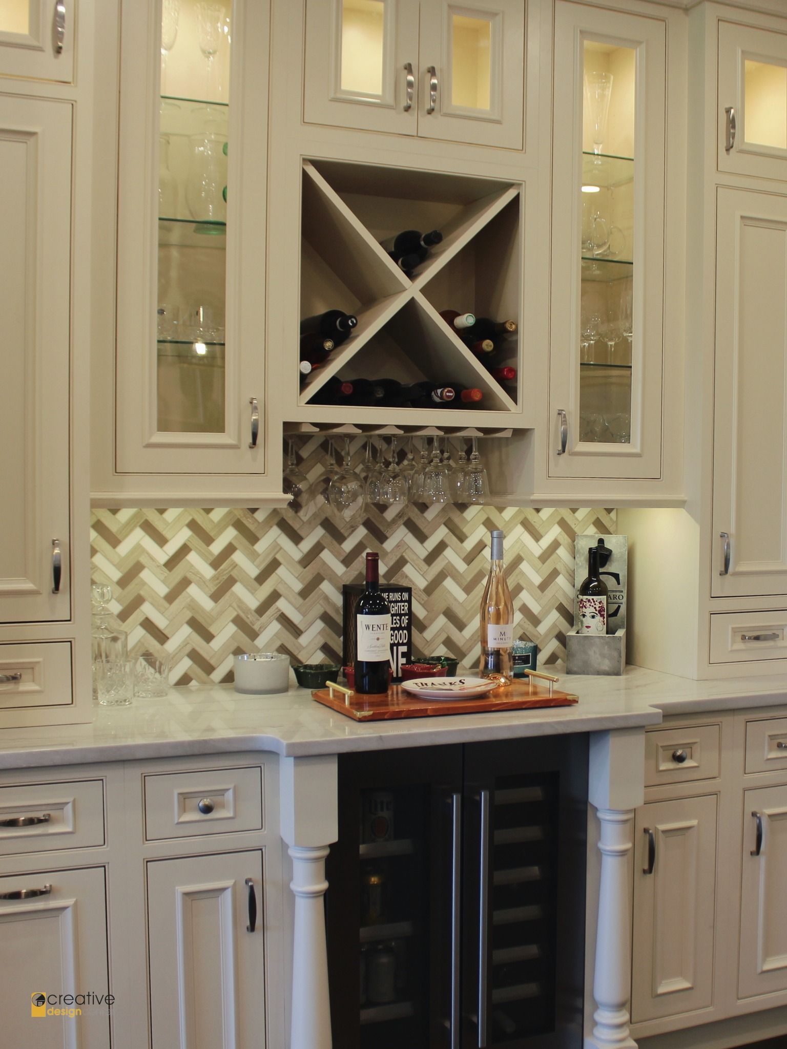 A bottle of wine sits on a counter in a kitchen.