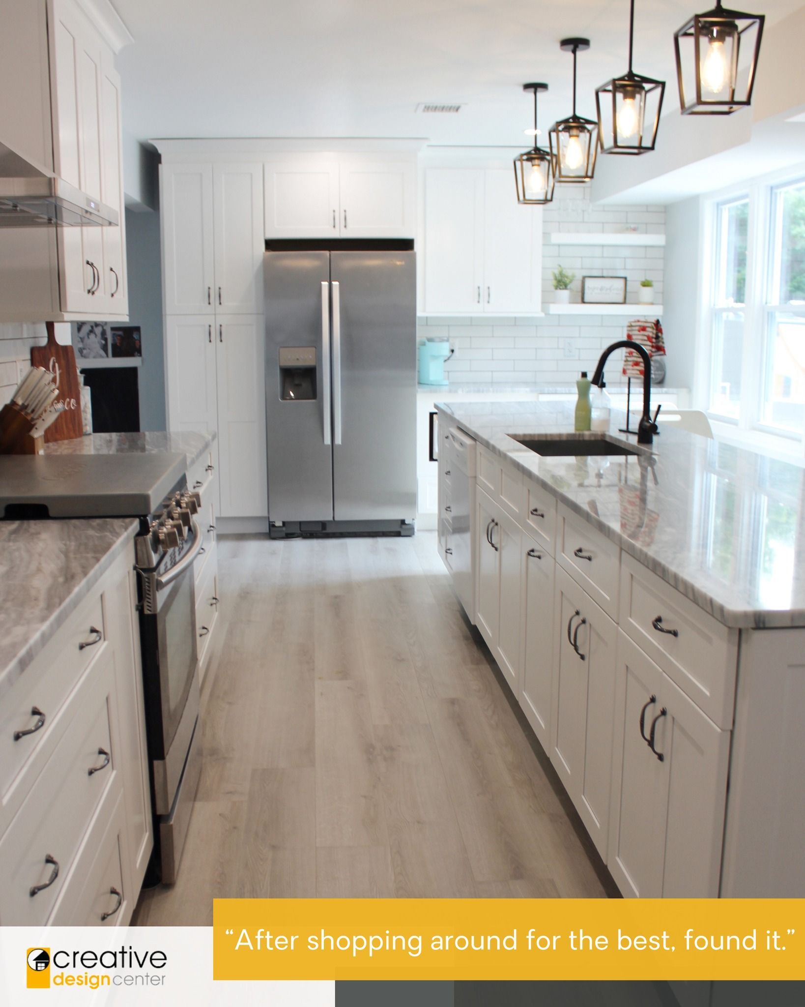 A kitchen with white cabinets, a stainless steel refrigerator, a sink, and a stove.