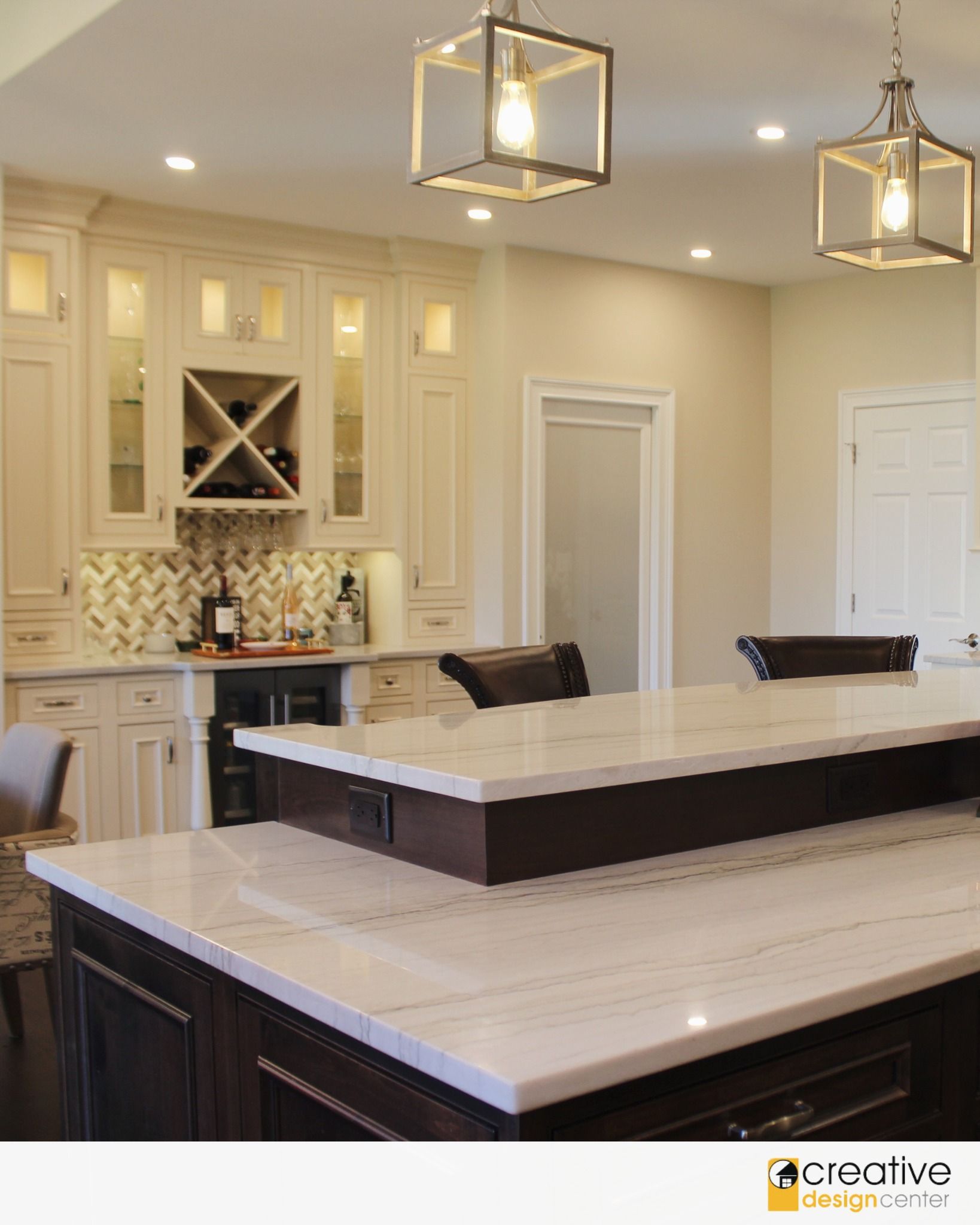 A kitchen with white cabinets and a large island.