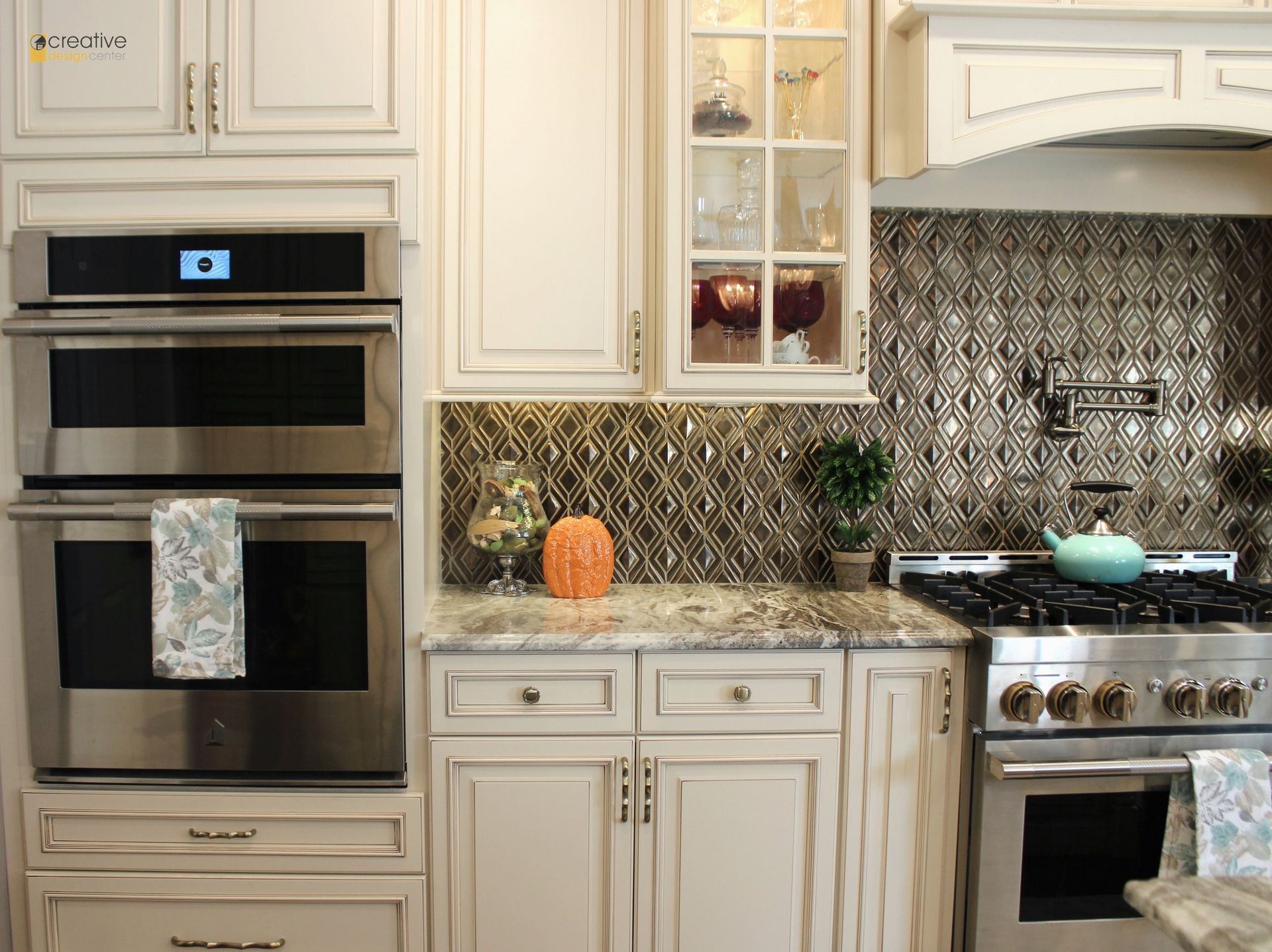 A kitchen with white cabinets and stainless steel appliances.
