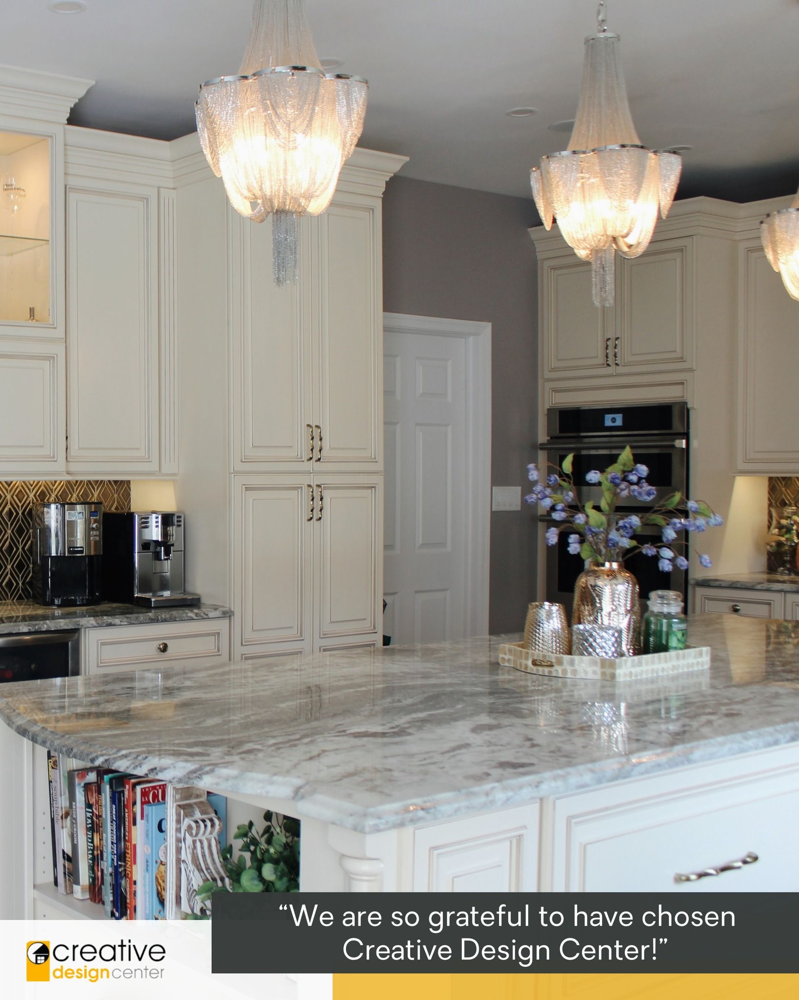 A kitchen with white cabinets and a marble counter top.