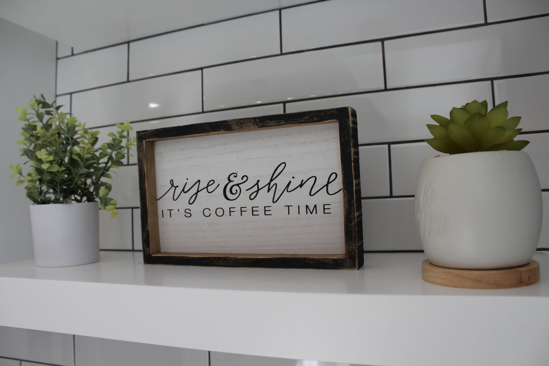 White kitchen cabinets with gray countertop, a drawer handle is visible.