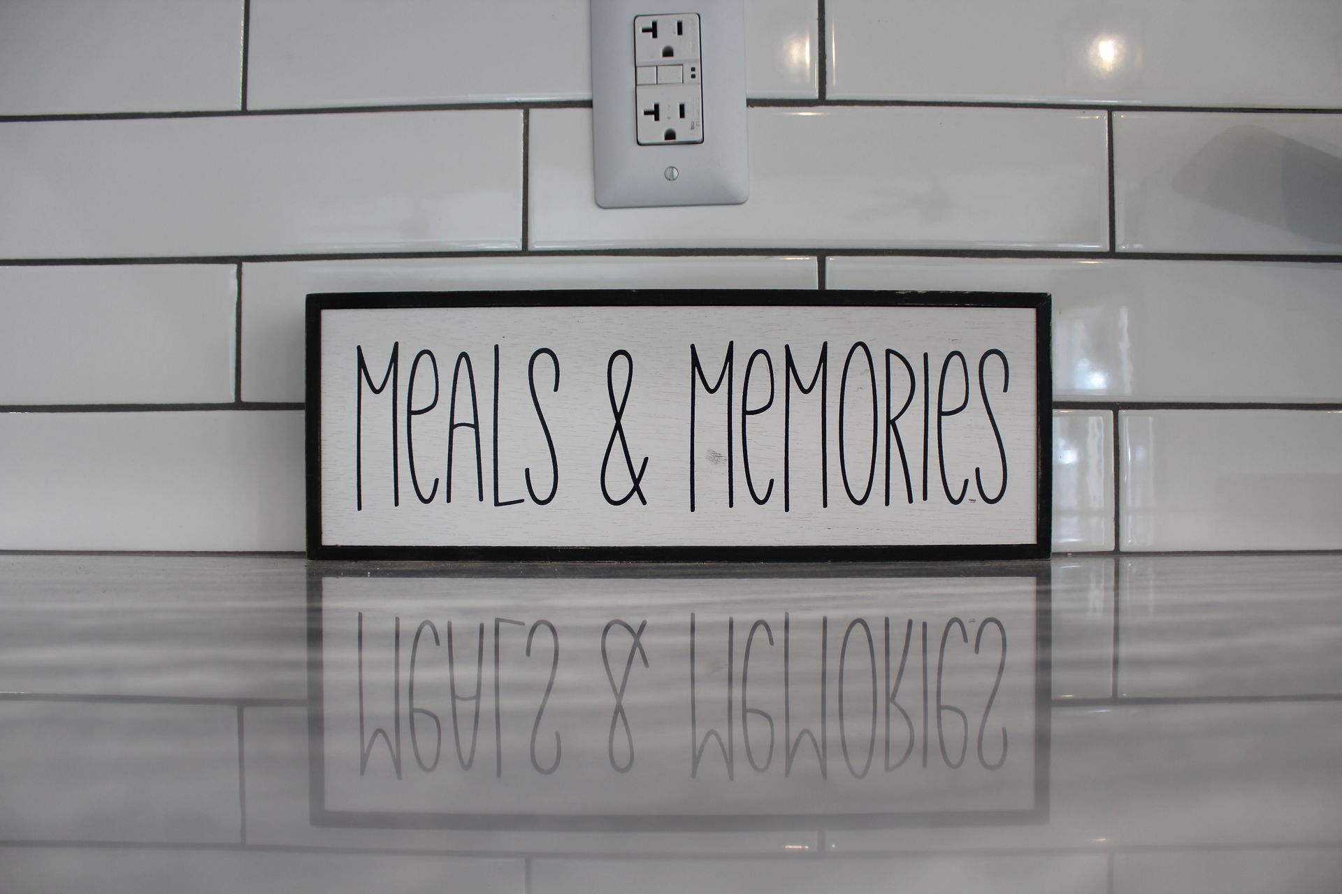 White kitchen with marble countertops, stainless steel appliances, and white cabinets.