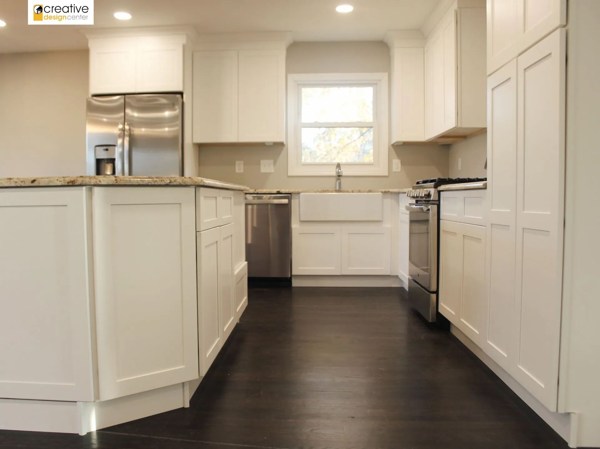 A kitchen with white cabinets and stainless steel appliances