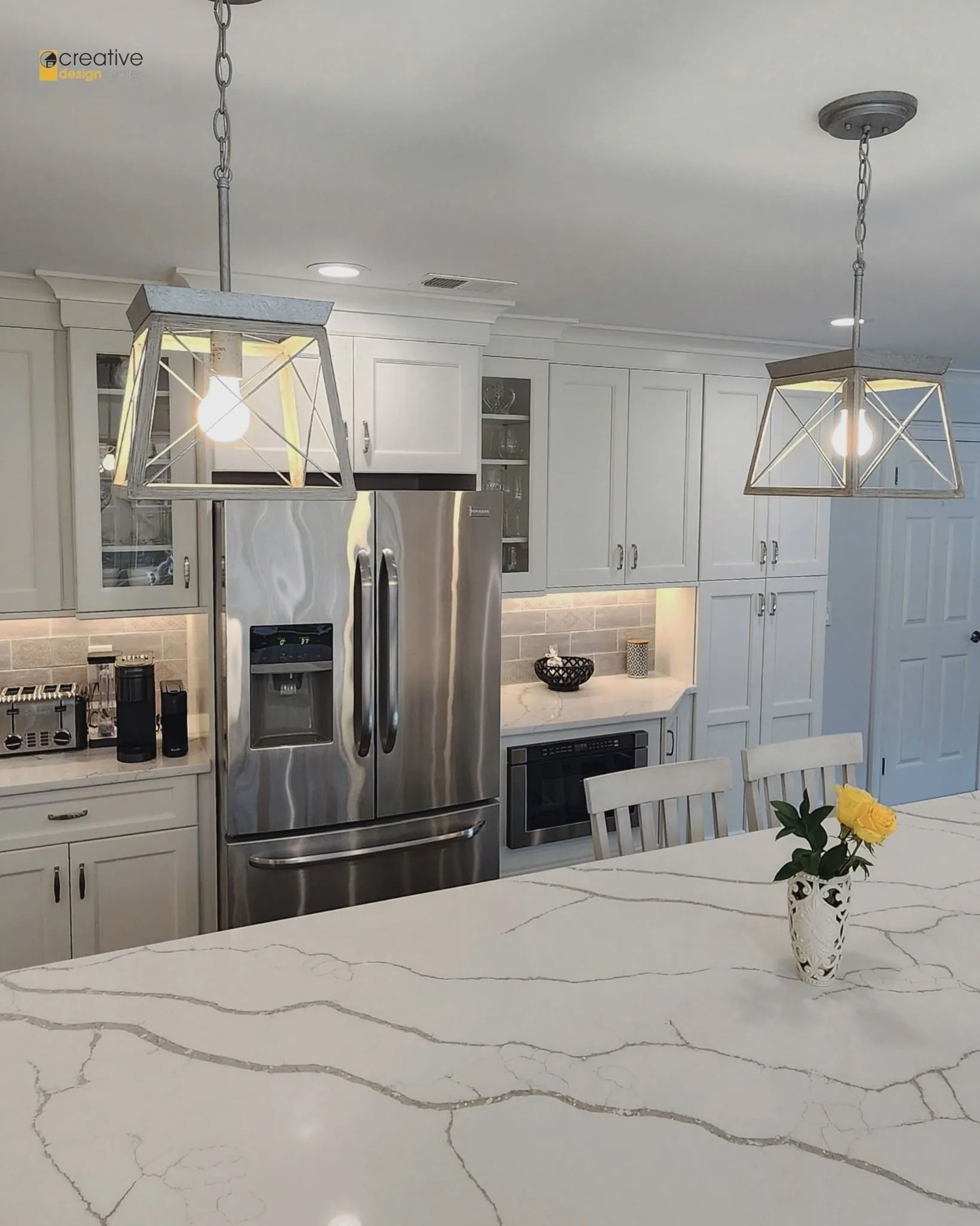 A kitchen with stainless steel appliances and white cabinets