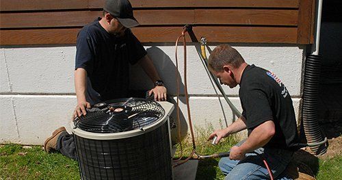 Two men installing an hvac unit