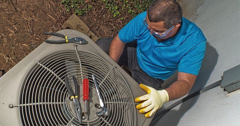 Man repairs hvac unit