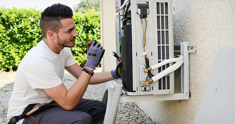 Man checking on the air conditioning unit