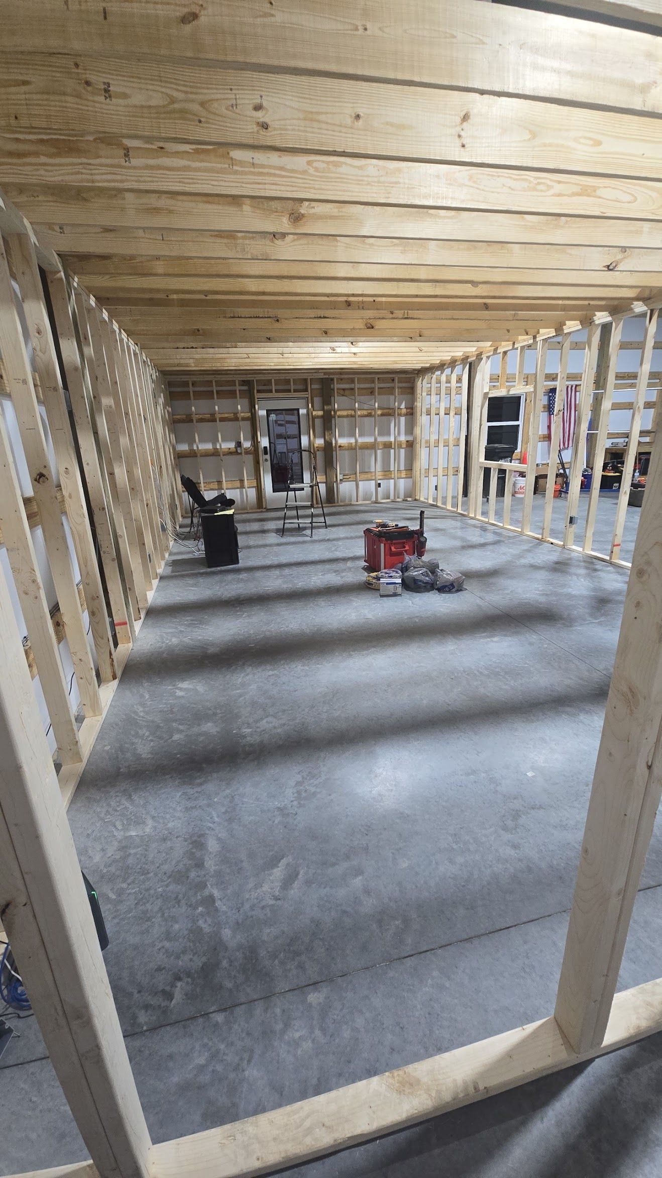 Interior view of a building under construction, framed with wooden beams