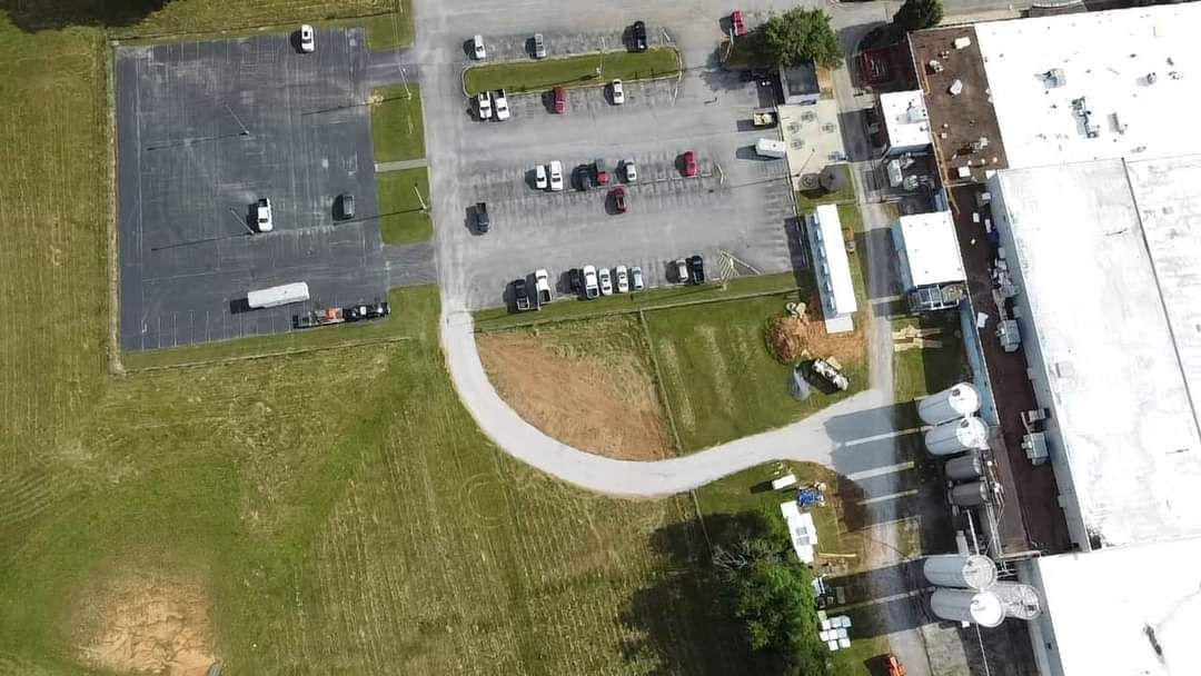 An aerial view of a parking lot and a building.