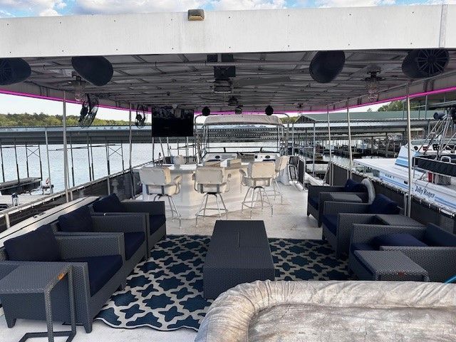 A large boat with furniture on the deck.