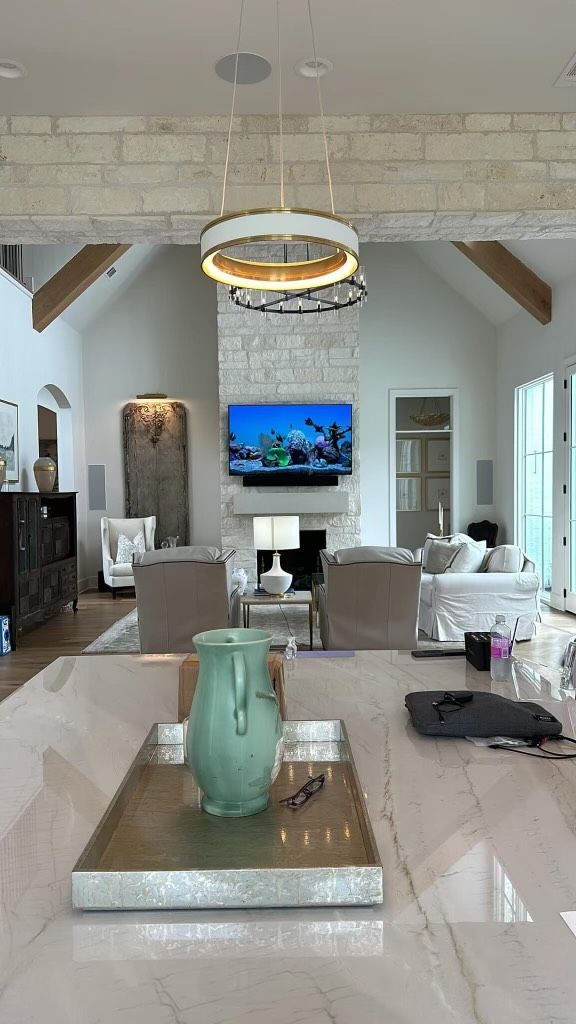 A living room with a tray on the table and a television on the wall.