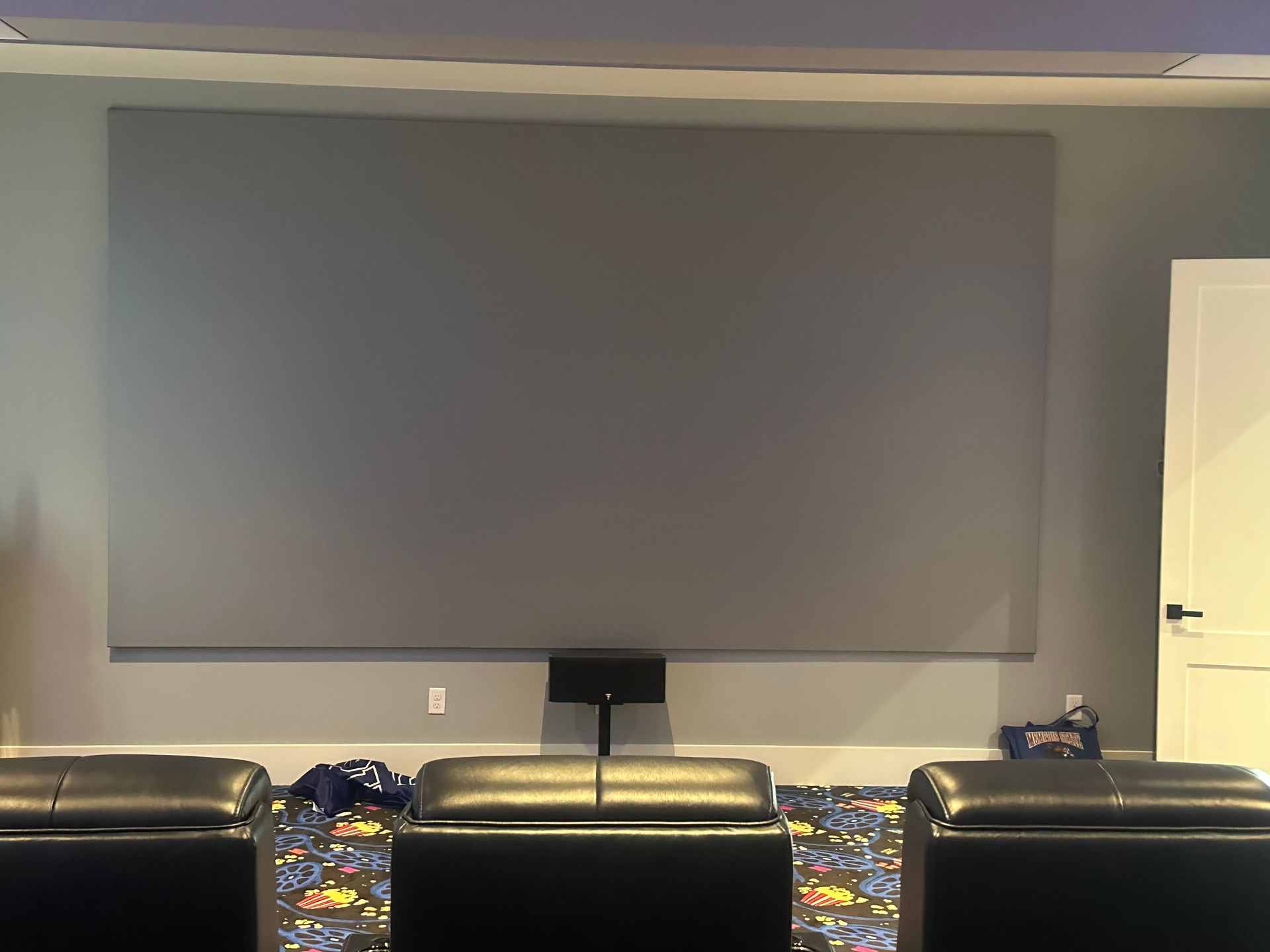 There is a large screen in the middle of the room.