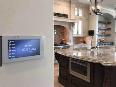 A kitchen with a large island and a thermostat on the wall