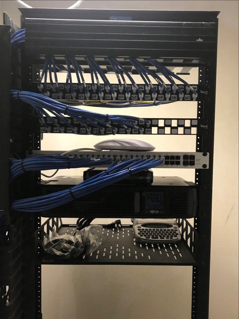 A server rack with a lot of blue wires on it