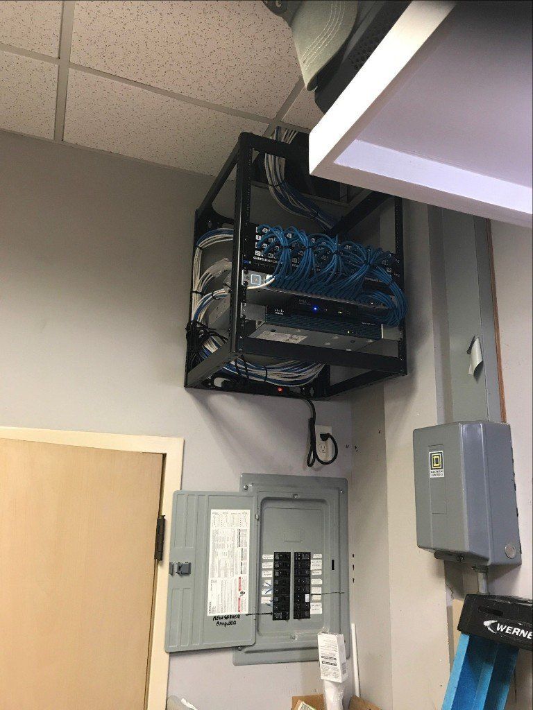 A ladder is hanging from the ceiling next to an electrical box