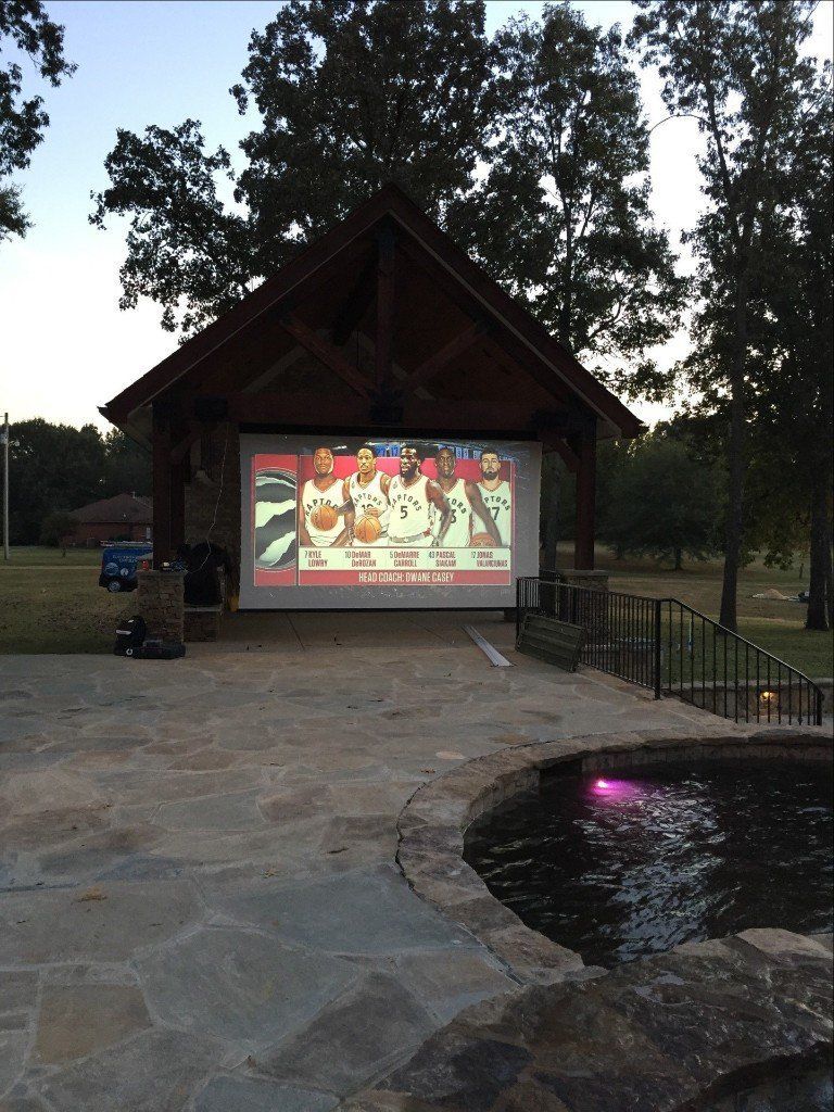 A projector screen shows a hockey game being played