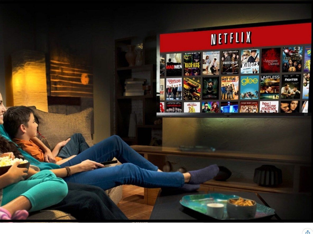 A group of people sitting on a couch watching netflix