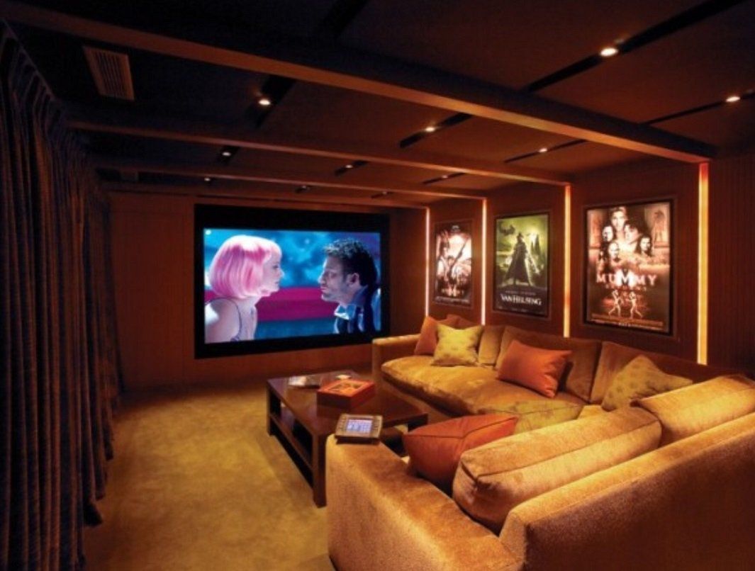 A home theater with a large screen and a couch