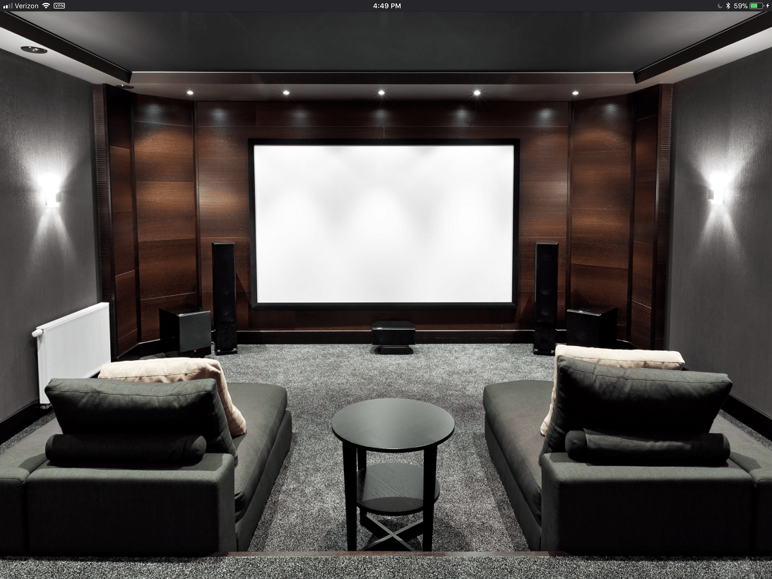 There is a projector screen in the middle of the room