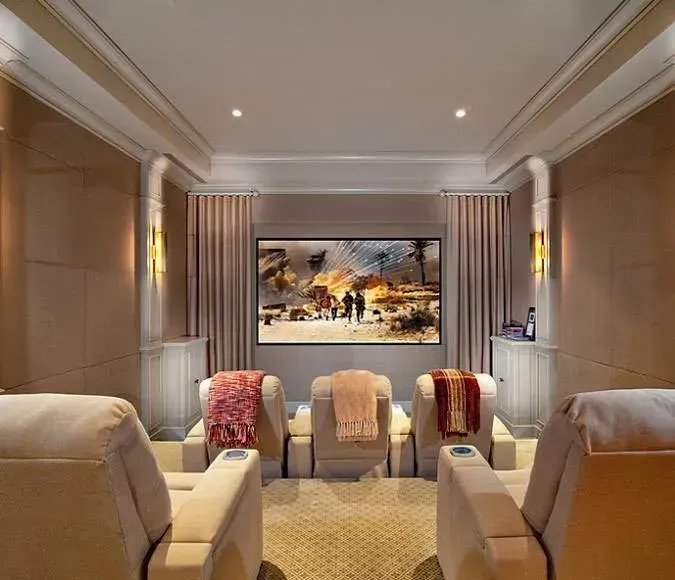 Elegant living room with beige chairs, striped drapes, and a framed landscape painting on the far wall.