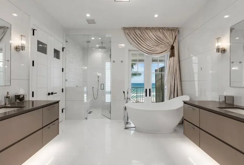 Bright modern bathroom with a freestanding tub, glass shower, and double vanity sinks