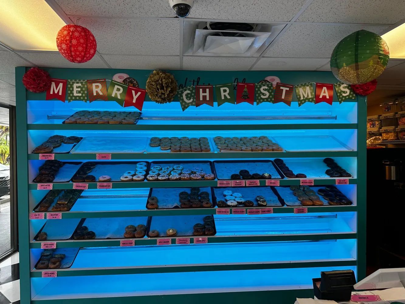 Christmas candy display on blue shelves with red, gold, and green decorations and “Merry Christmas” banner