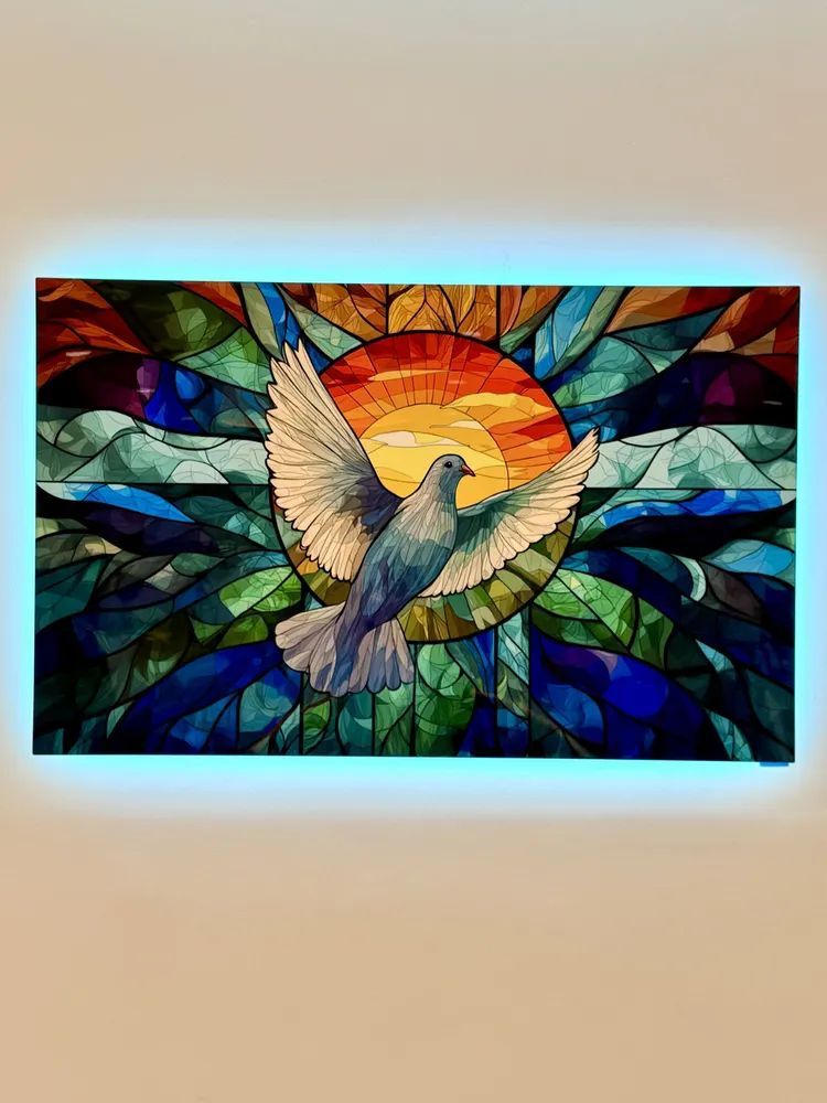 Stained-glass-style hummingbird with outstretched wings before a sunset, in blue and green tones