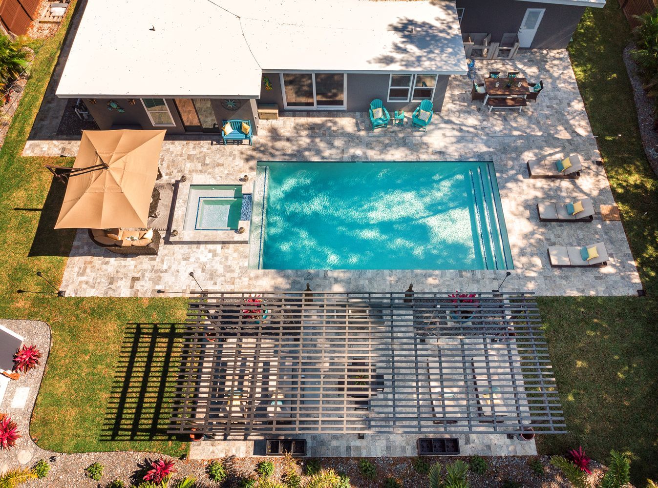 An aerial view of a house with a large swimming pool