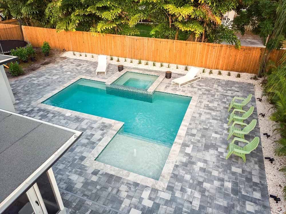 An aerial view of a large swimming pool in a backyard.