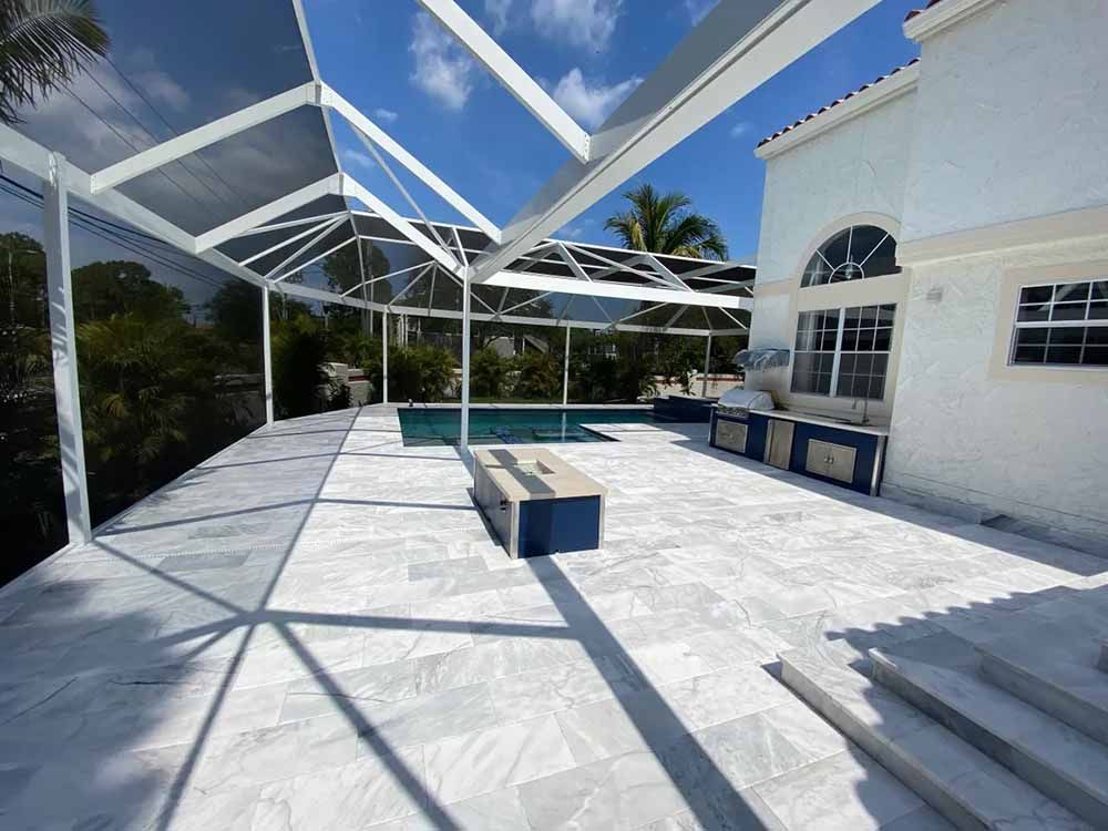 A white house with a swimming pool and a patio