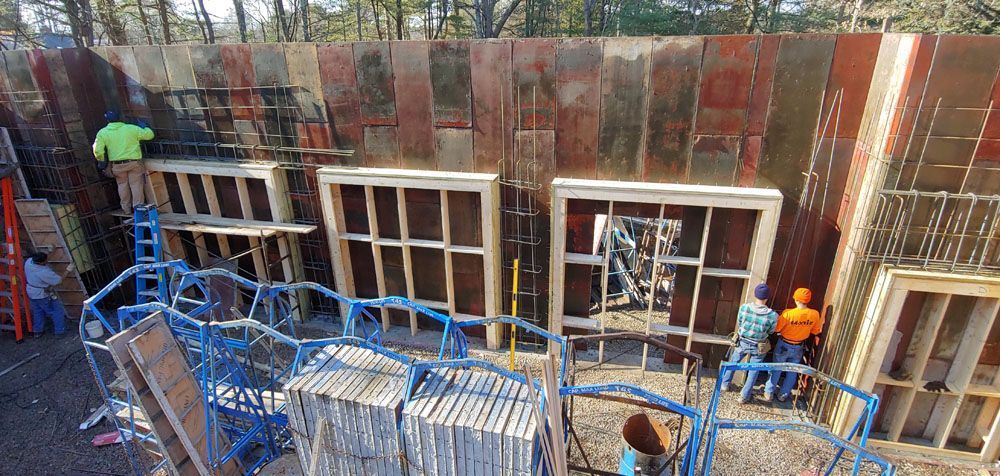 A group of construction workers are working on a building.