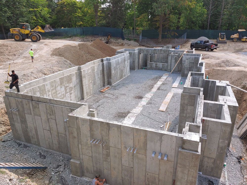 An aerial view of a large concrete basement under construction.