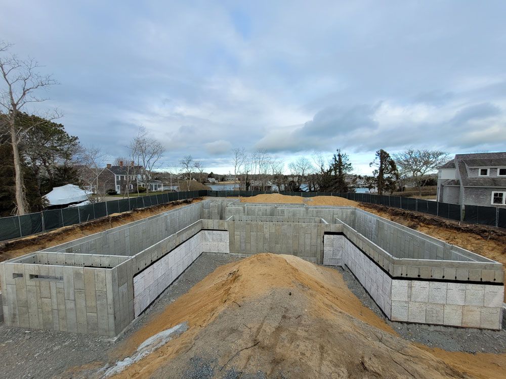 A large concrete structure is being built in the middle of a dirt field.