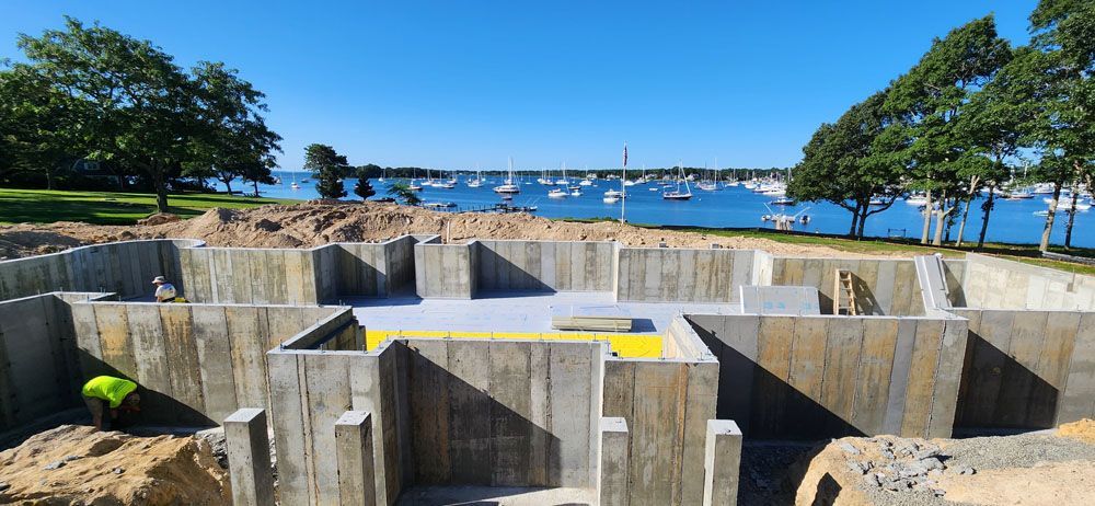 A concrete basement is being built next to a body of water.