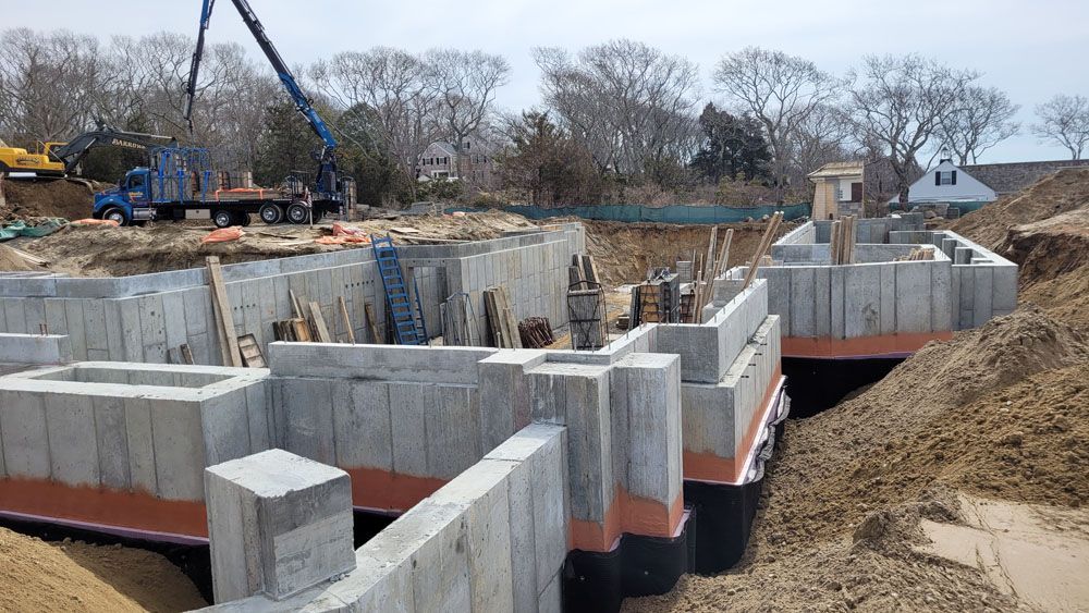 A large concrete foundation is being built in a construction site.