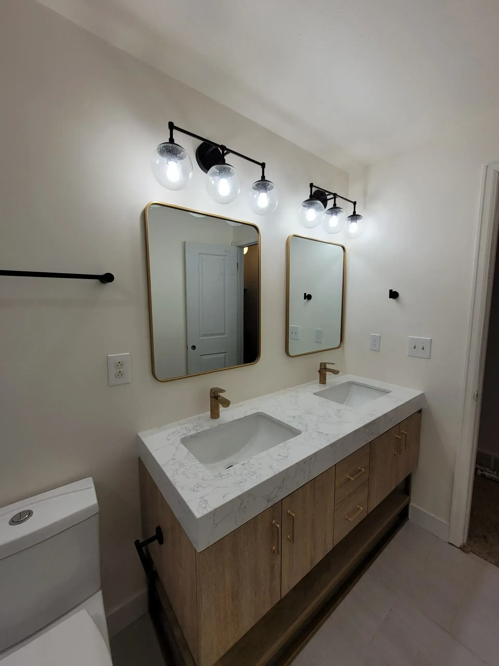 A bathroom with two sinks and two mirrors