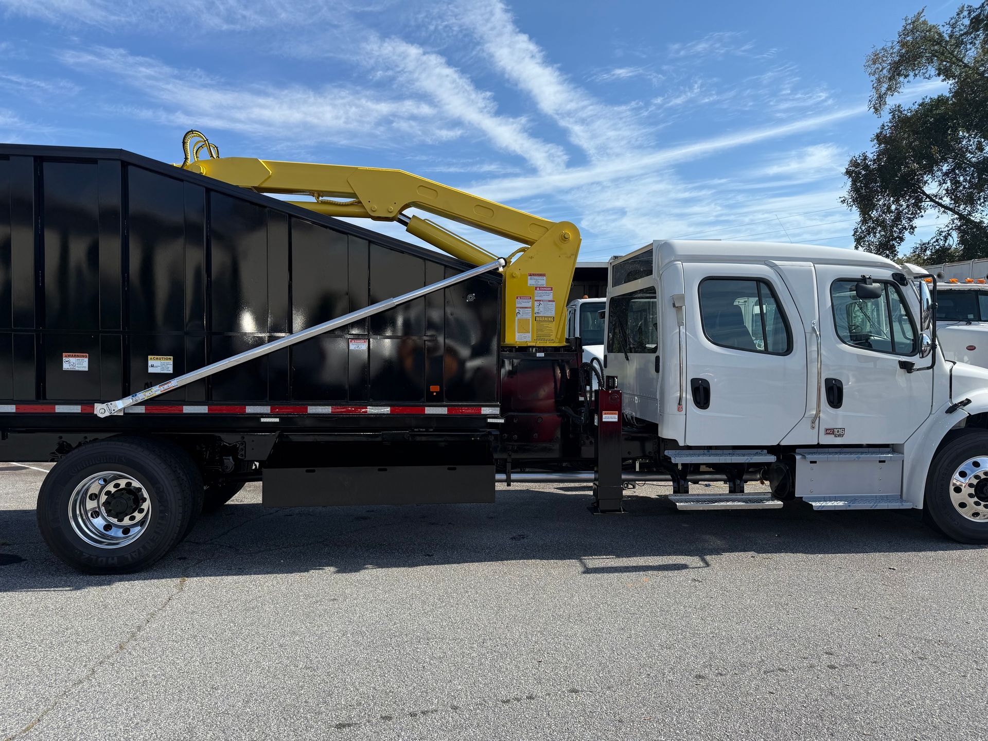 A dump truck is parked in a parking lot.