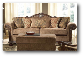 a living room with a brown couch and ottoman