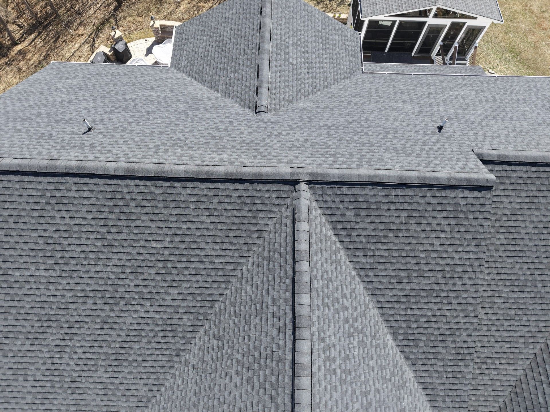 Gray shingled roof with dormer and skylight on a house