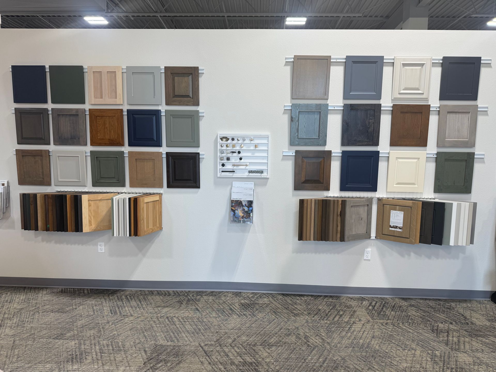 There are many different types of cabinet doors on display on the wall.