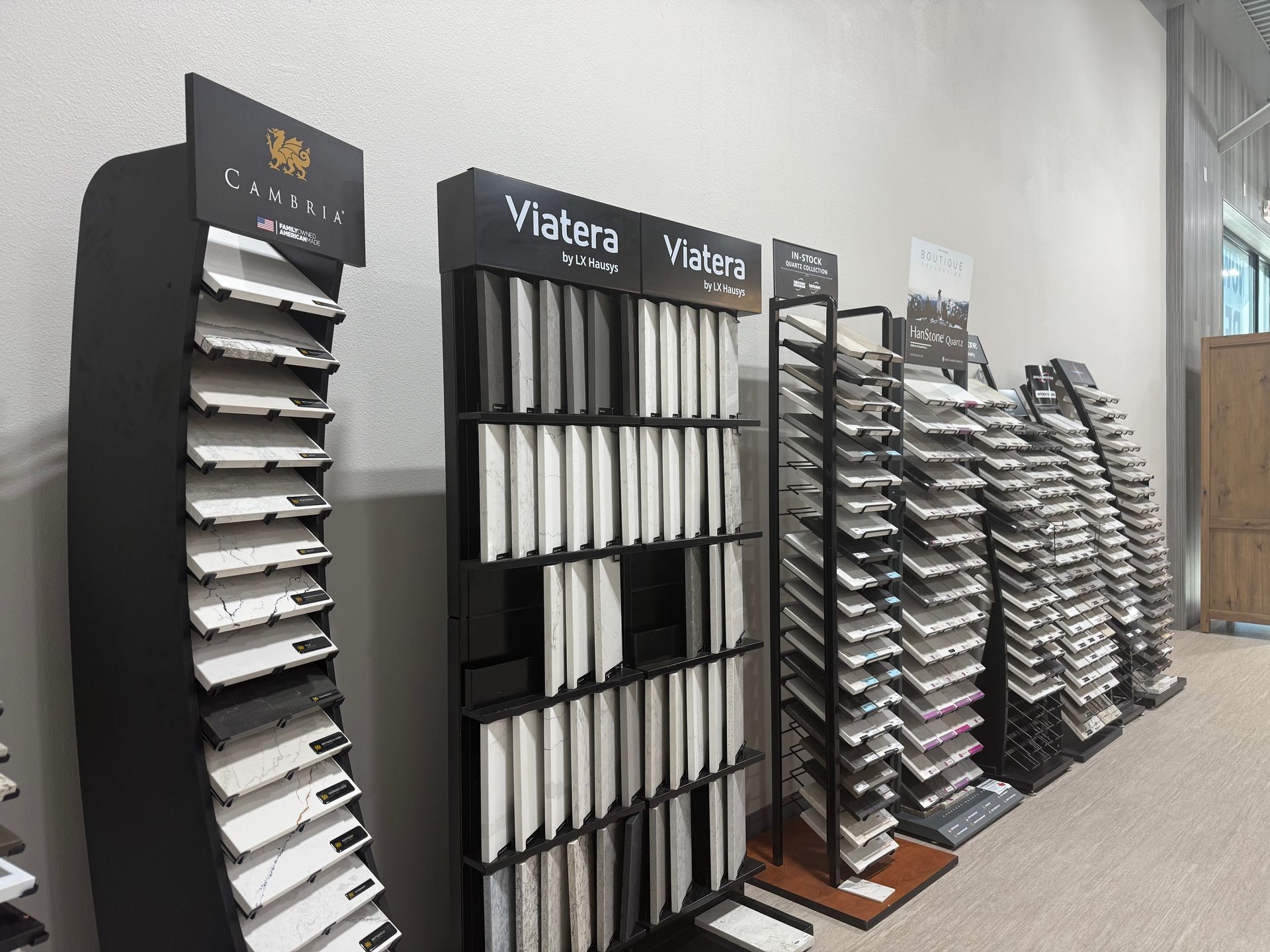 A room filled with lots of display stands filled with different types of tiles.