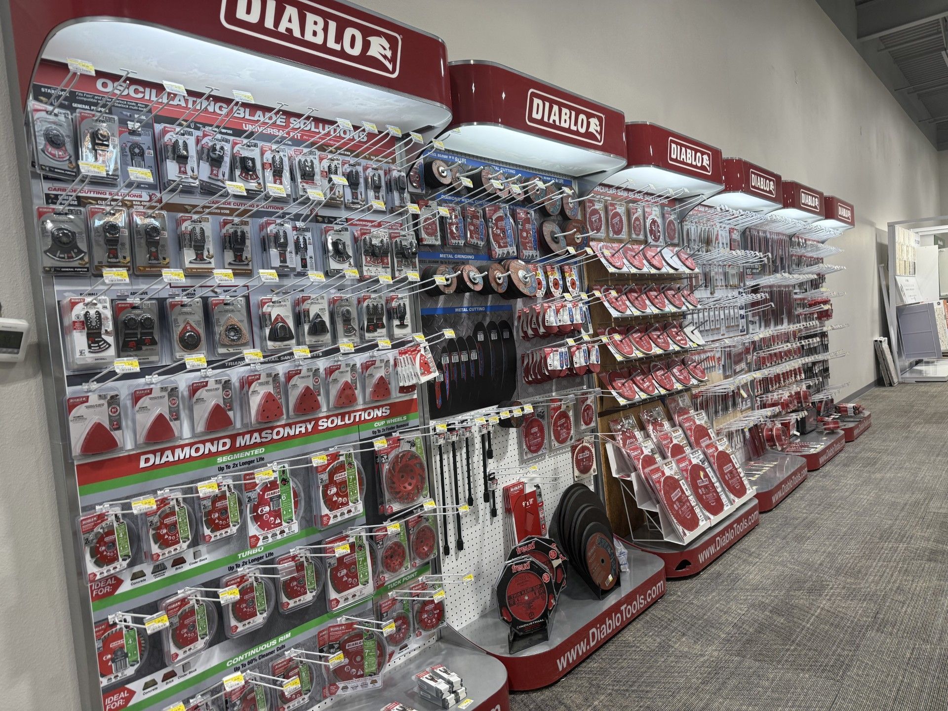 A row of shelves filled with lots of different items in a store.