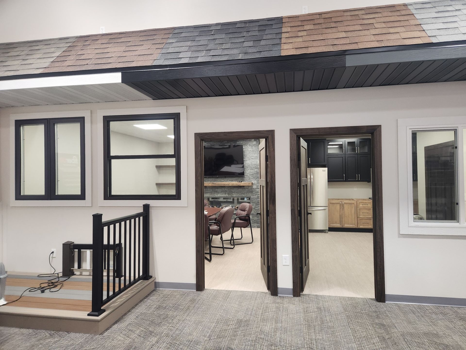 A room with a lot of windows and a fireplace